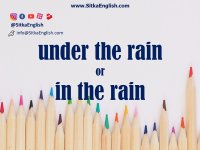 under the rain or in the rain